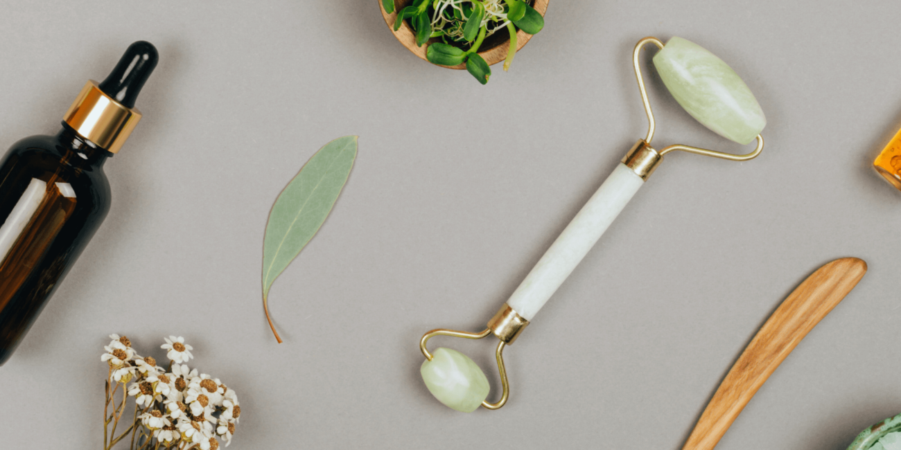 Natural skincare tools including jade roller and facial oils at Boss Beauty Bar Academy spa
