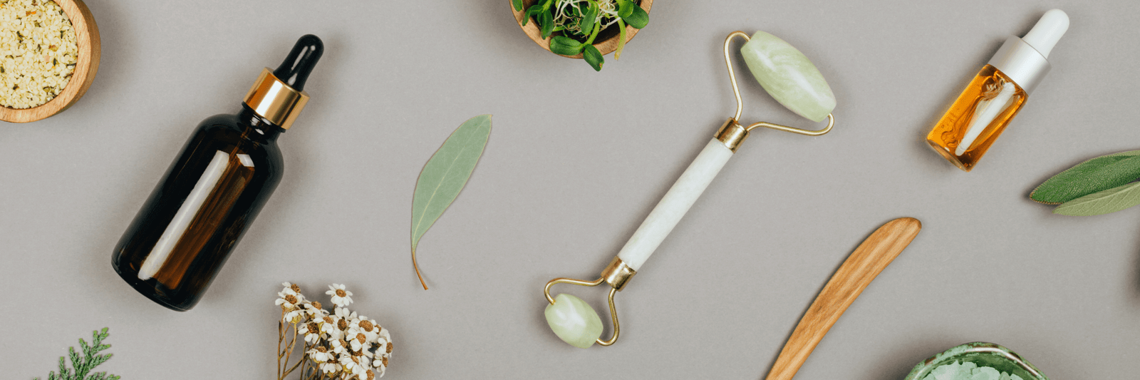 Natural skincare tools including jade roller and facial oils at Boss Beauty Bar Academy spa