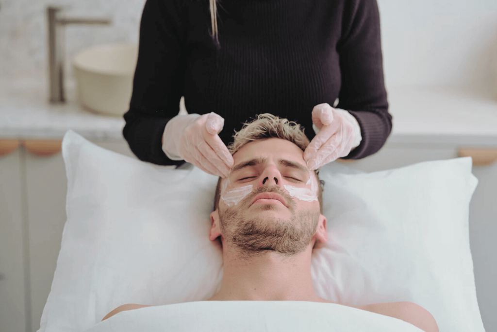 Male client receiving chemical peel treatment at BossBeautyBar for smoother skin.