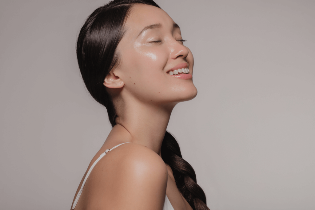 Woman with smooth, glowing skin after Restylane services at BossBeautyBar.