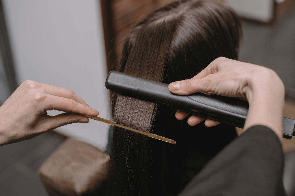 Stylist performing Taninoplastia hair treatment at BossBeautyBar.
