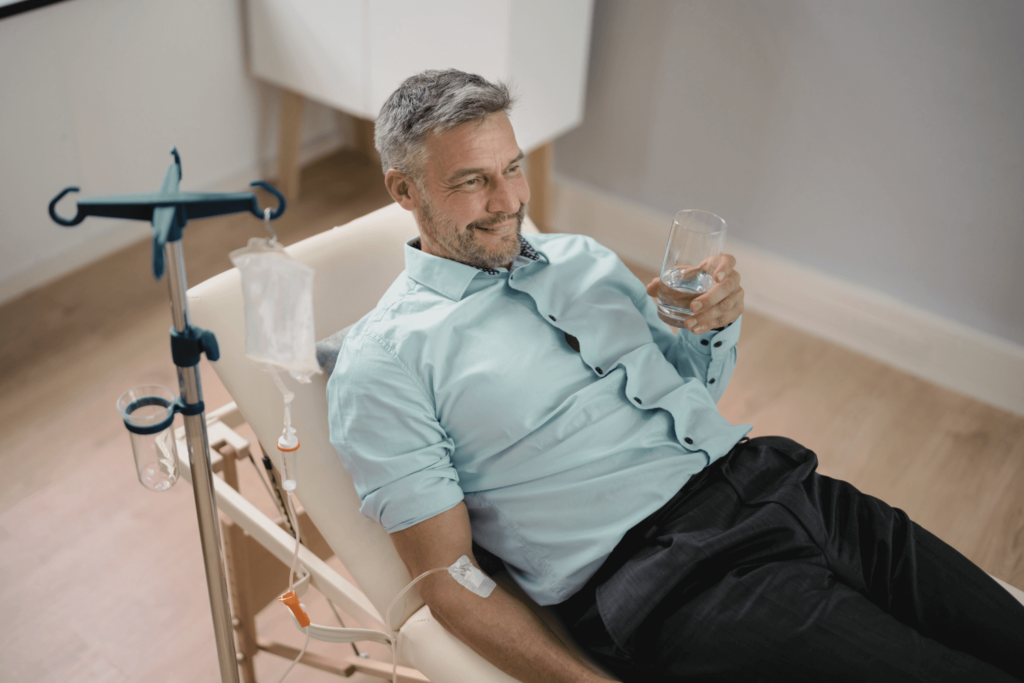 Man receiving IV drip therapy at Boss Beauty Bar for hydration and skin brightening.