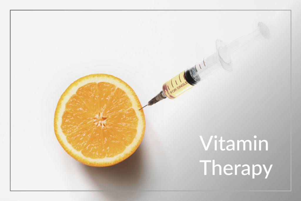A syringe injecting a vibrant orange slice, representing Vitamin Therapy benefits at Boss Beauty Bar.