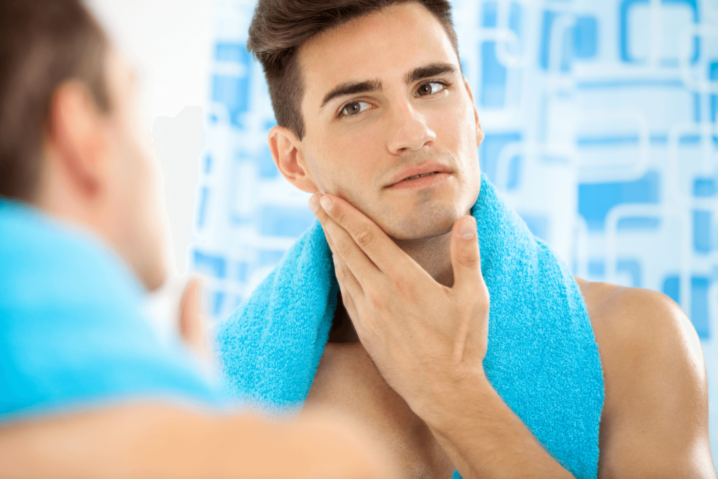 A man with rejuvenated, glowing skin touching his face after an NAD therapy session.