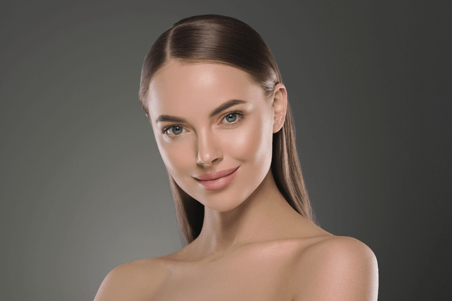 Smiling woman with glowing skin after facial at Boss Beauty Bar Academy